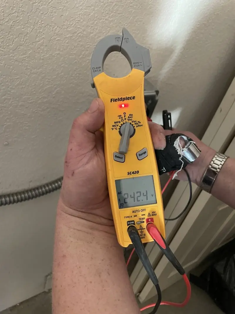 Voltage testing with clamp meter during Recessed Lighting Installation in Negaunee
